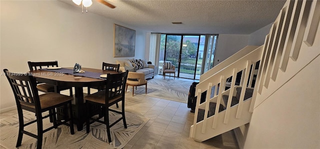 dining room featuring ceiling fan, floor to ceiling windows, and a textured ceiling