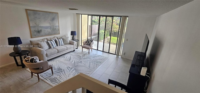 living room featuring a wall of windows, a textured ceiling, and baseboards