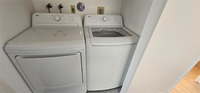 washroom with laundry area and washer and dryer