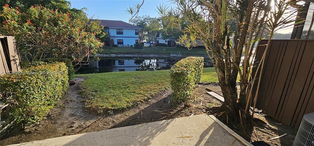 view of yard featuring a water view and fence