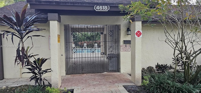 entrance to property with stucco siding