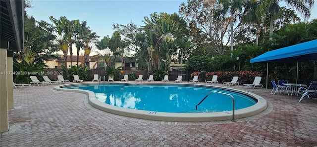 pool featuring a patio and fence