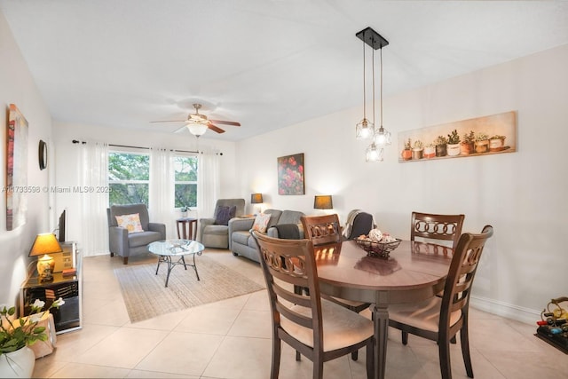 tiled dining space featuring ceiling fan