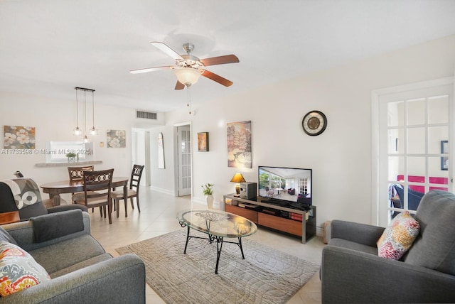 living room with light tile patterned floors and ceiling fan