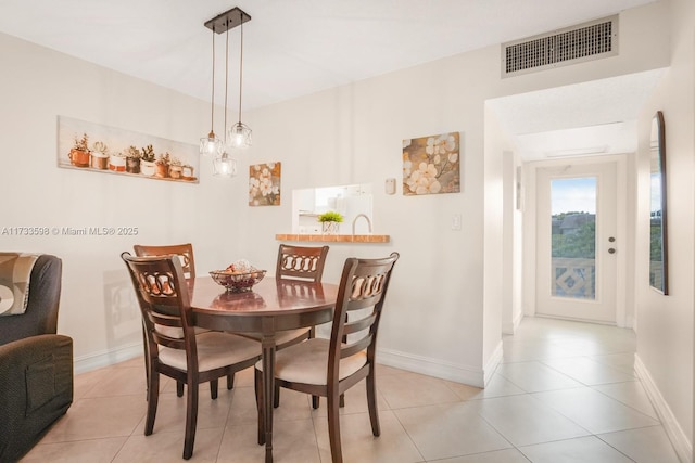 dining space featuring light tile patterned flooring