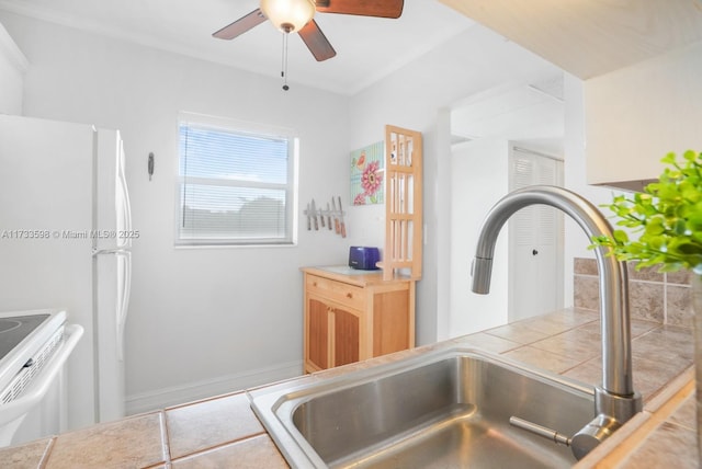 kitchen with ceiling fan, sink, tile countertops, and white appliances