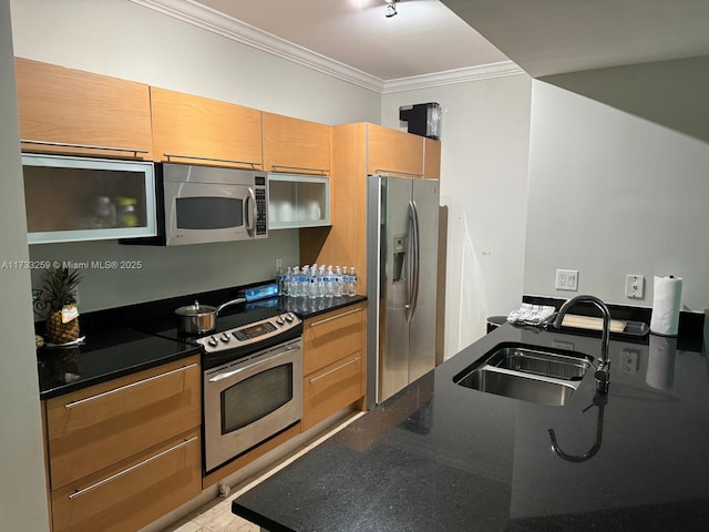 kitchen featuring ornamental molding, appliances with stainless steel finishes, sink, and dark stone countertops