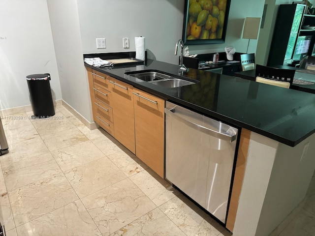 kitchen with stainless steel dishwasher, dark stone counters, kitchen peninsula, and sink