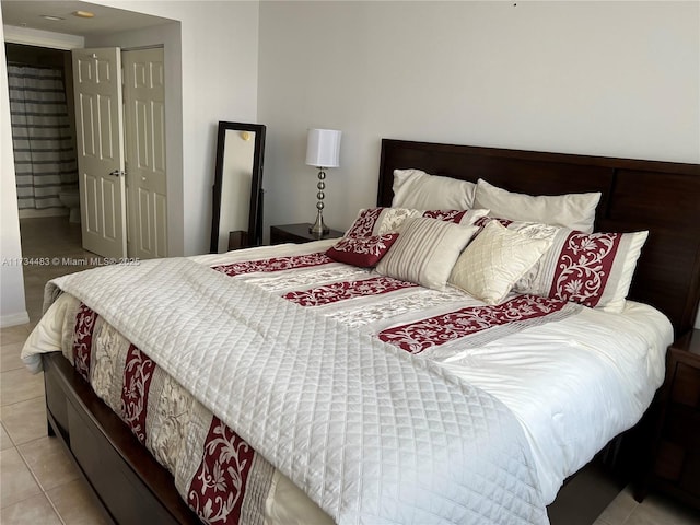 bedroom featuring a closet and light tile patterned floors