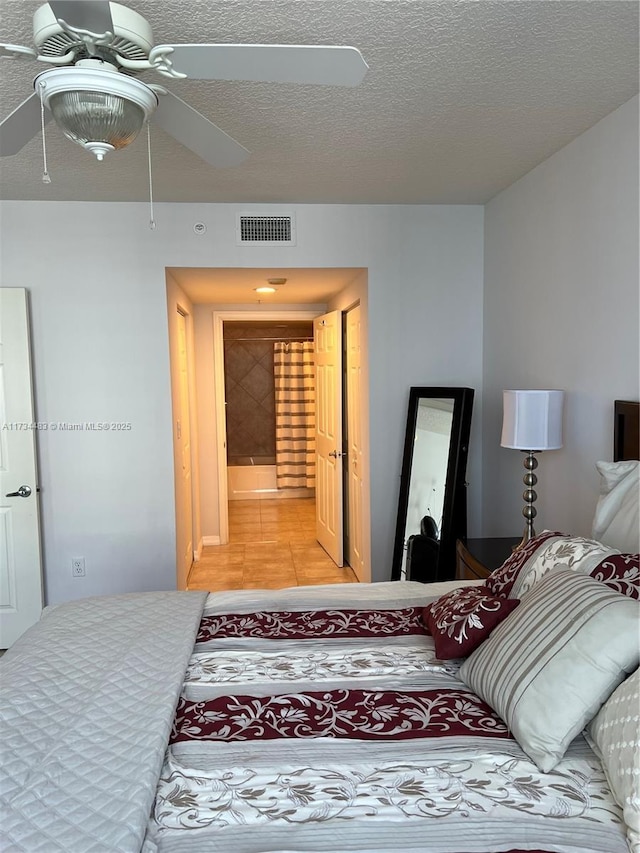 tiled bedroom with a textured ceiling