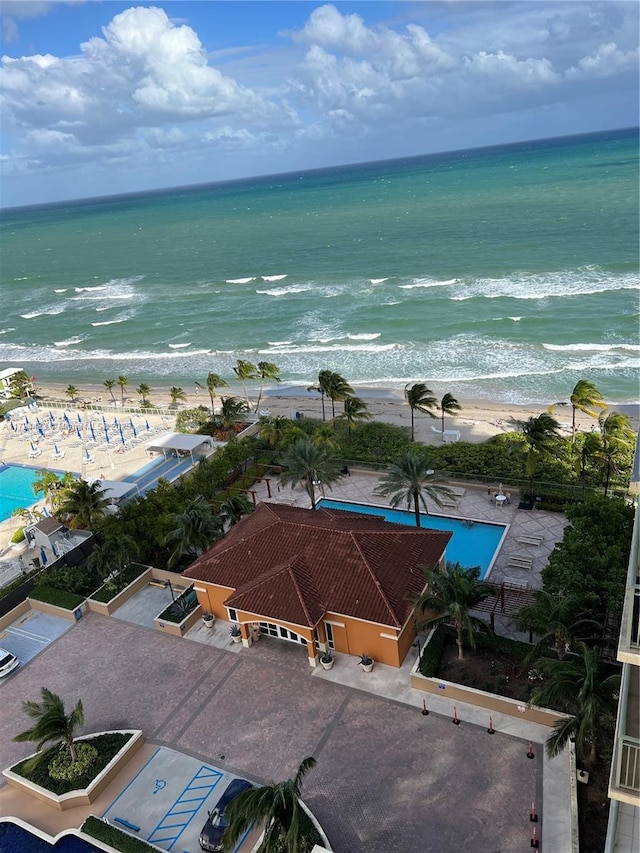 birds eye view of property featuring a water view and a beach view