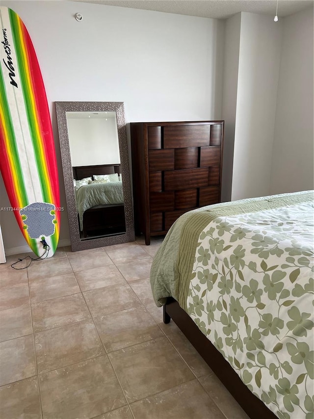 bedroom with light tile patterned floors