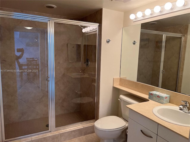 bathroom with vanity, tile patterned floors, toilet, and walk in shower