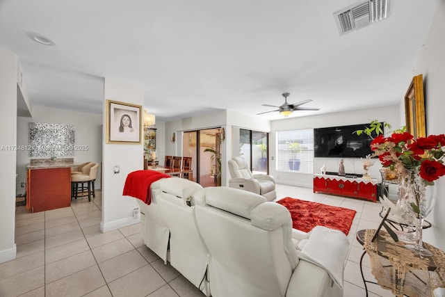 tiled living room featuring ceiling fan