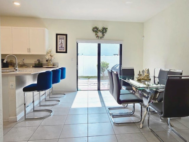 dining space with sink and light tile patterned flooring