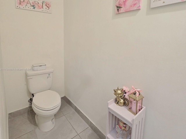 bathroom with toilet and tile patterned flooring