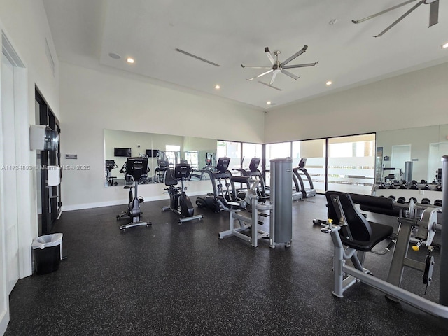 exercise room featuring a towering ceiling and ceiling fan