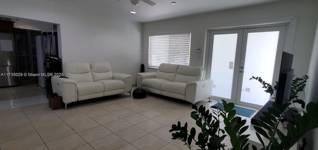 living room with light tile patterned floors, ceiling fan, and french doors