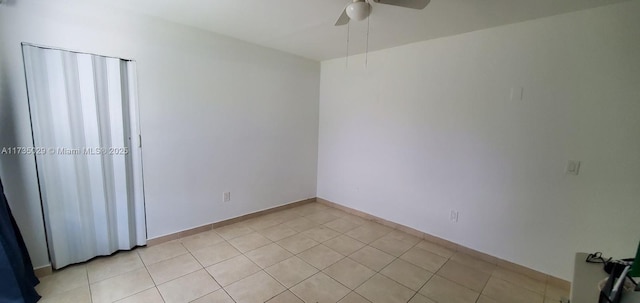 unfurnished room with light tile patterned floors and ceiling fan