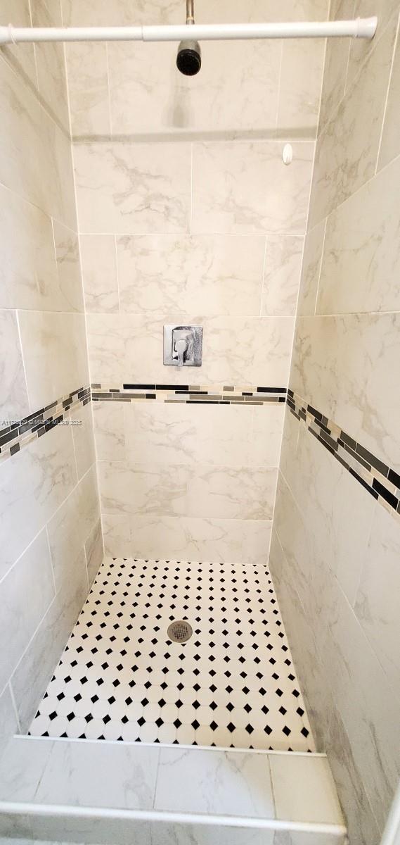 bathroom with a tile shower