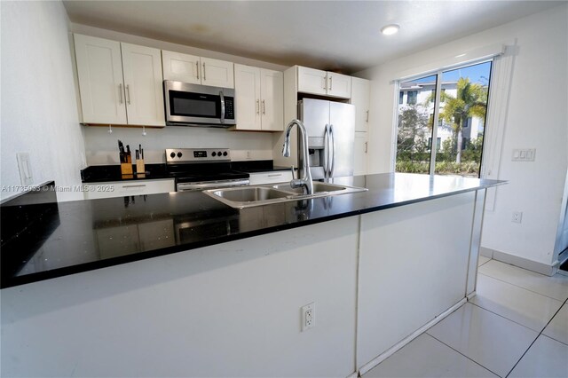 kitchen featuring sink, stainless steel appliances, white cabinets, and light tile patterned flooring