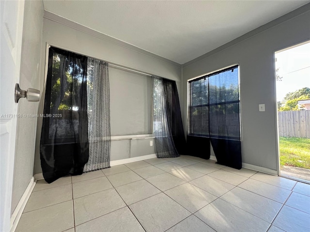 unfurnished room featuring light tile patterned floors