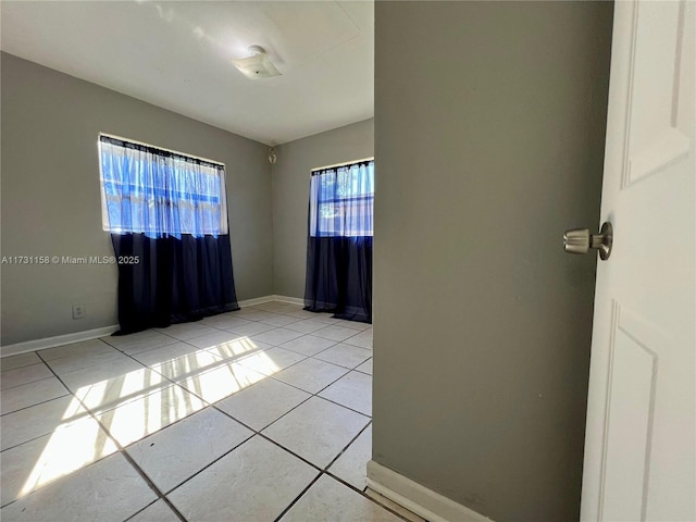 unfurnished room with light tile patterned floors