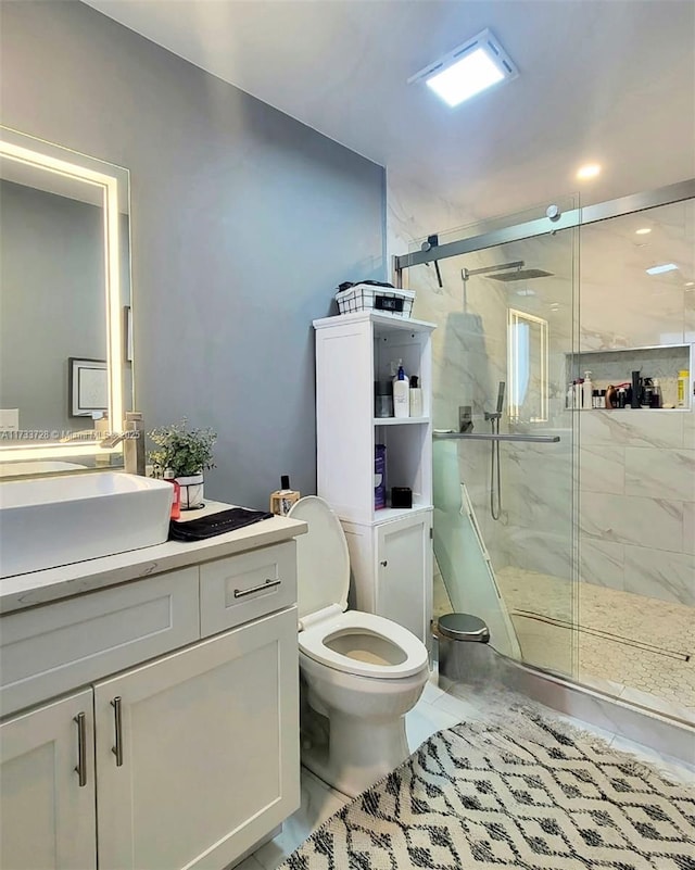 bathroom with vanity, an enclosed shower, and toilet