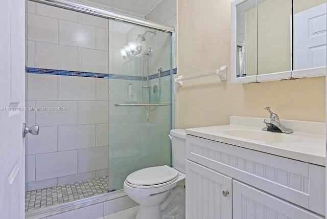 bathroom with vanity, toilet, and walk in shower