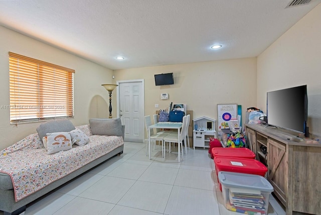 bedroom with light tile patterned floors and a textured ceiling