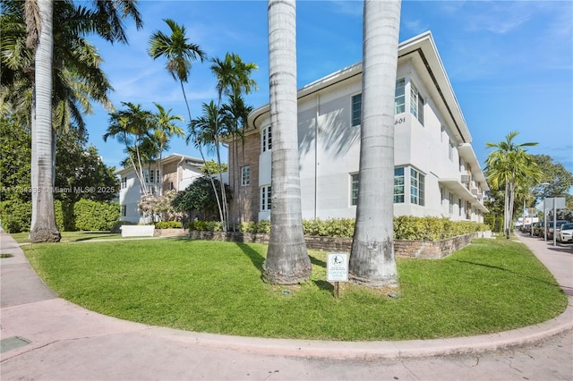 view of property exterior with a lawn