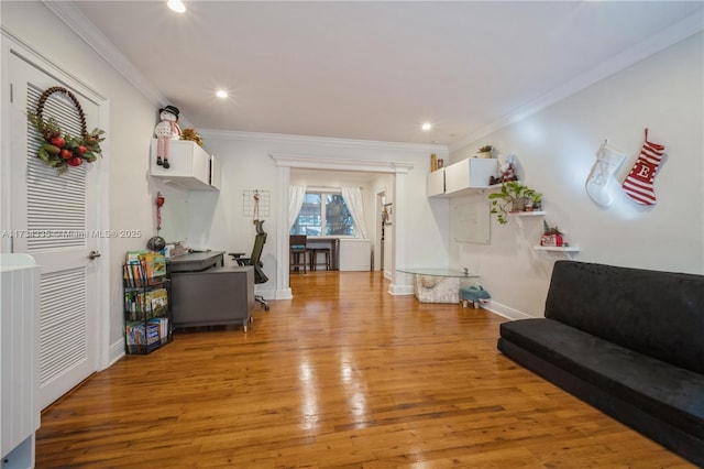 interior space featuring crown molding and light hardwood / wood-style floors