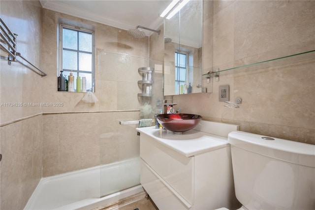 bathroom with tile walls, decorative backsplash, vanity, tiled shower, and crown molding