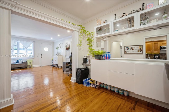 interior space featuring ornamental molding and light hardwood / wood-style floors