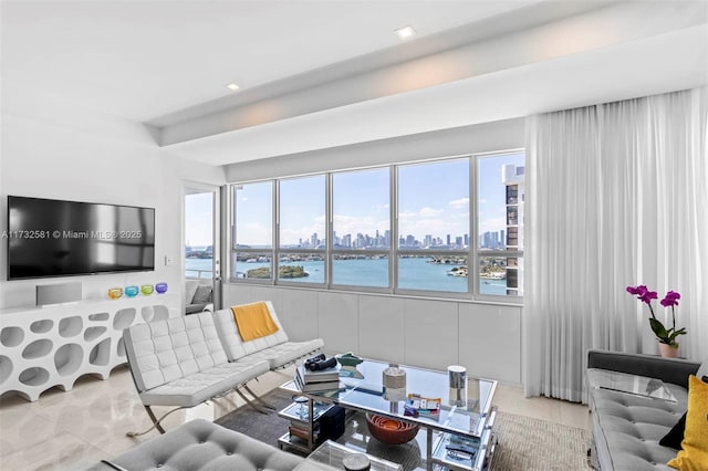 living room with light tile patterned floors and a water view