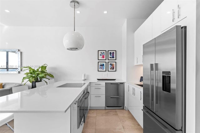 kitchen with pendant lighting, high end refrigerator, kitchen peninsula, and white cabinets