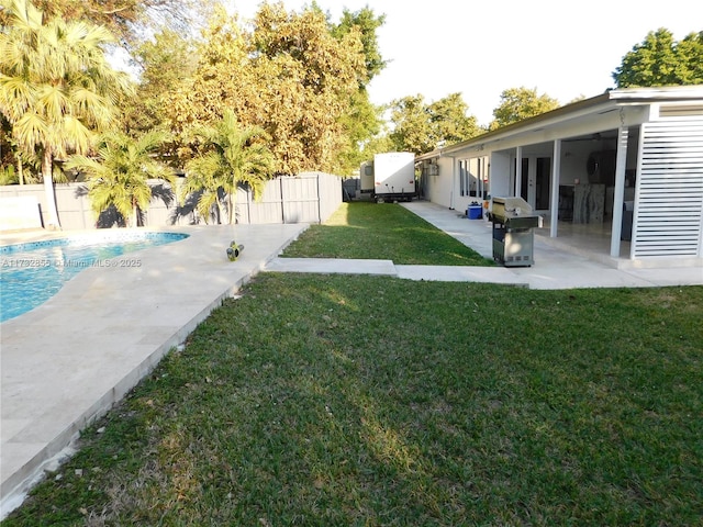 view of yard with a fenced in pool and a patio