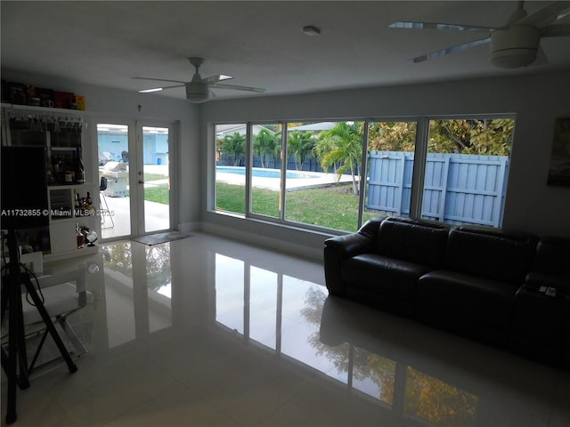 living room with tile patterned flooring, french doors, and ceiling fan