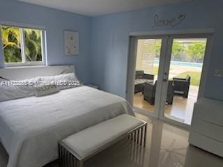 bedroom with french doors and multiple windows