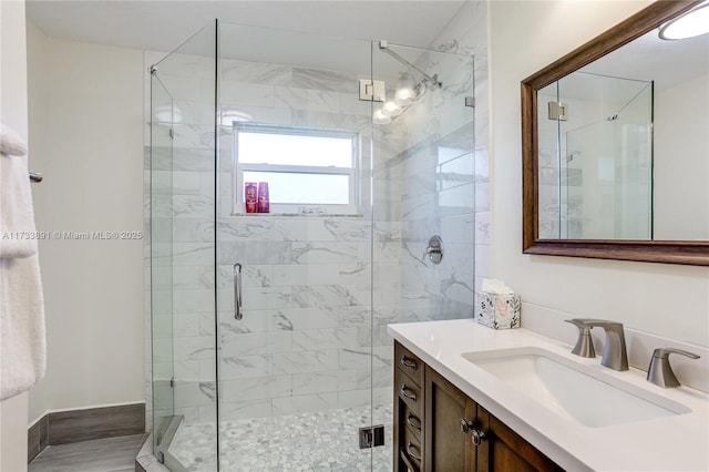 bathroom with vanity and a shower with shower door