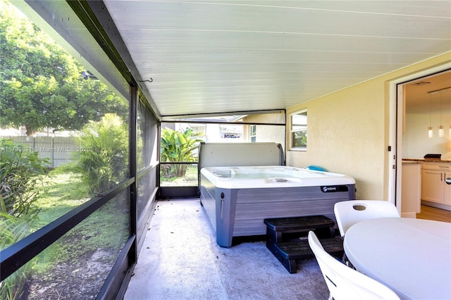 unfurnished sunroom featuring a hot tub