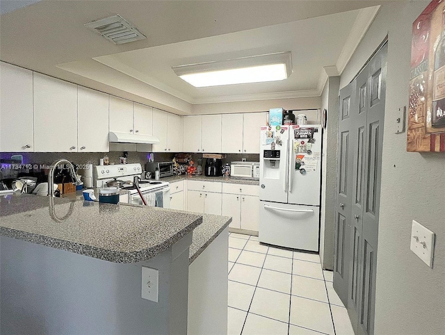 kitchen featuring light tile patterned flooring, white cabinets, ornamental molding, kitchen peninsula, and white appliances