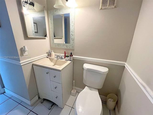 bathroom featuring vanity, tile patterned floors, and toilet