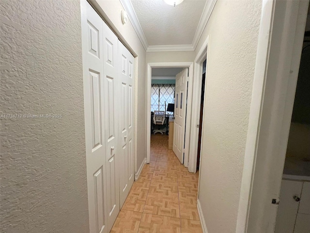 corridor with light parquet floors, ornamental molding, and a textured ceiling