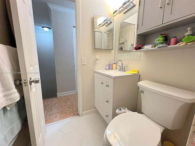 bathroom with vanity, parquet floors, and toilet