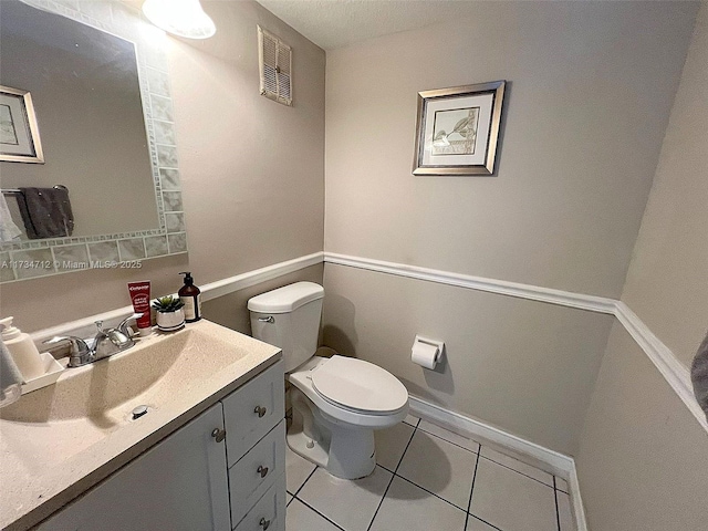 bathroom with tile patterned floors, vanity, and toilet