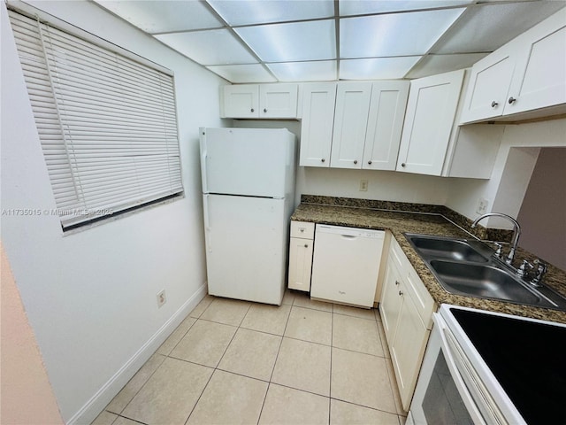 kitchen featuring white appliances, light tile patterned floors, sink, and white cabinets