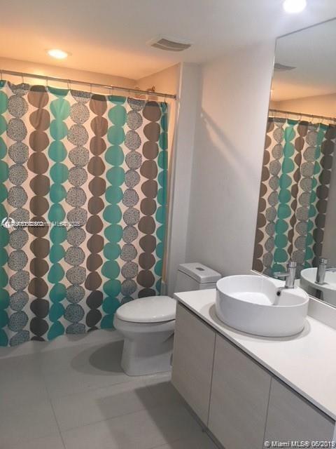 bathroom with vanity, a shower with curtain, tile patterned floors, and toilet