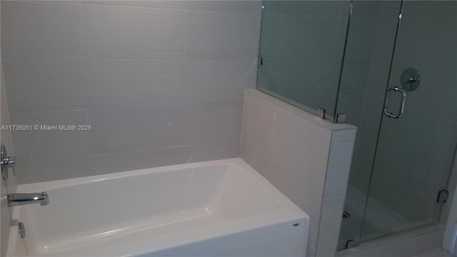 bathroom with separate shower and tub