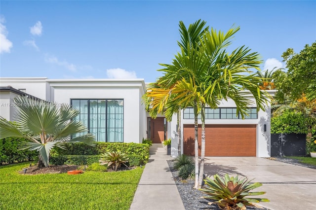 view of front facade with a garage and a front lawn